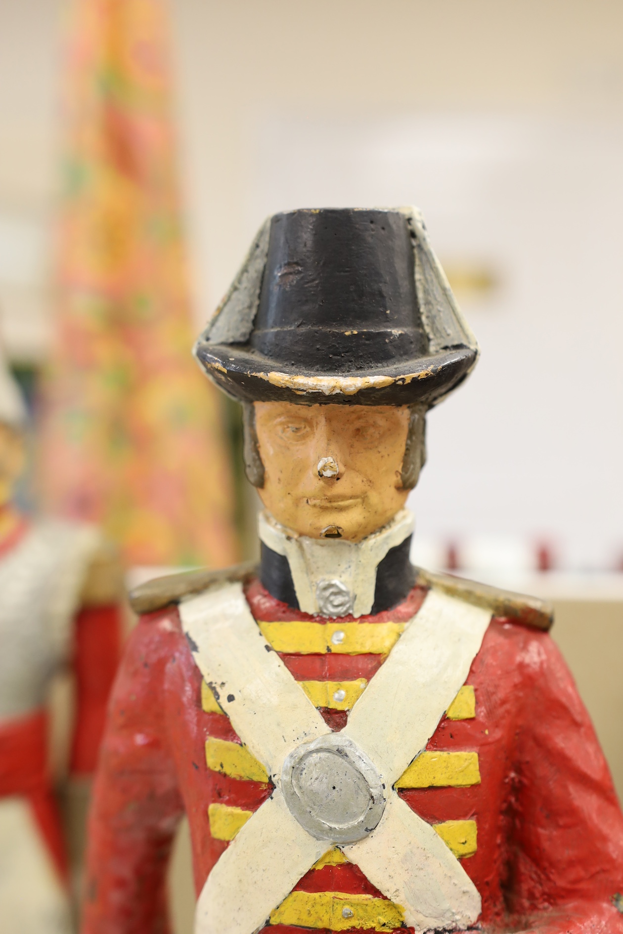 A pair of painted figures of soldiers in military dress, 49cm high. Condition - fair